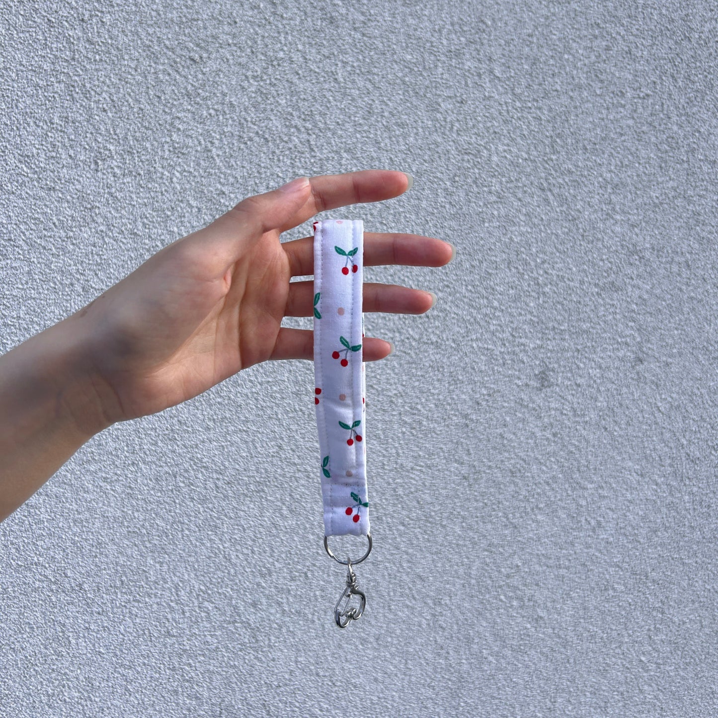 Cherry Heart Wristlet key holder held vertically with visible clasp